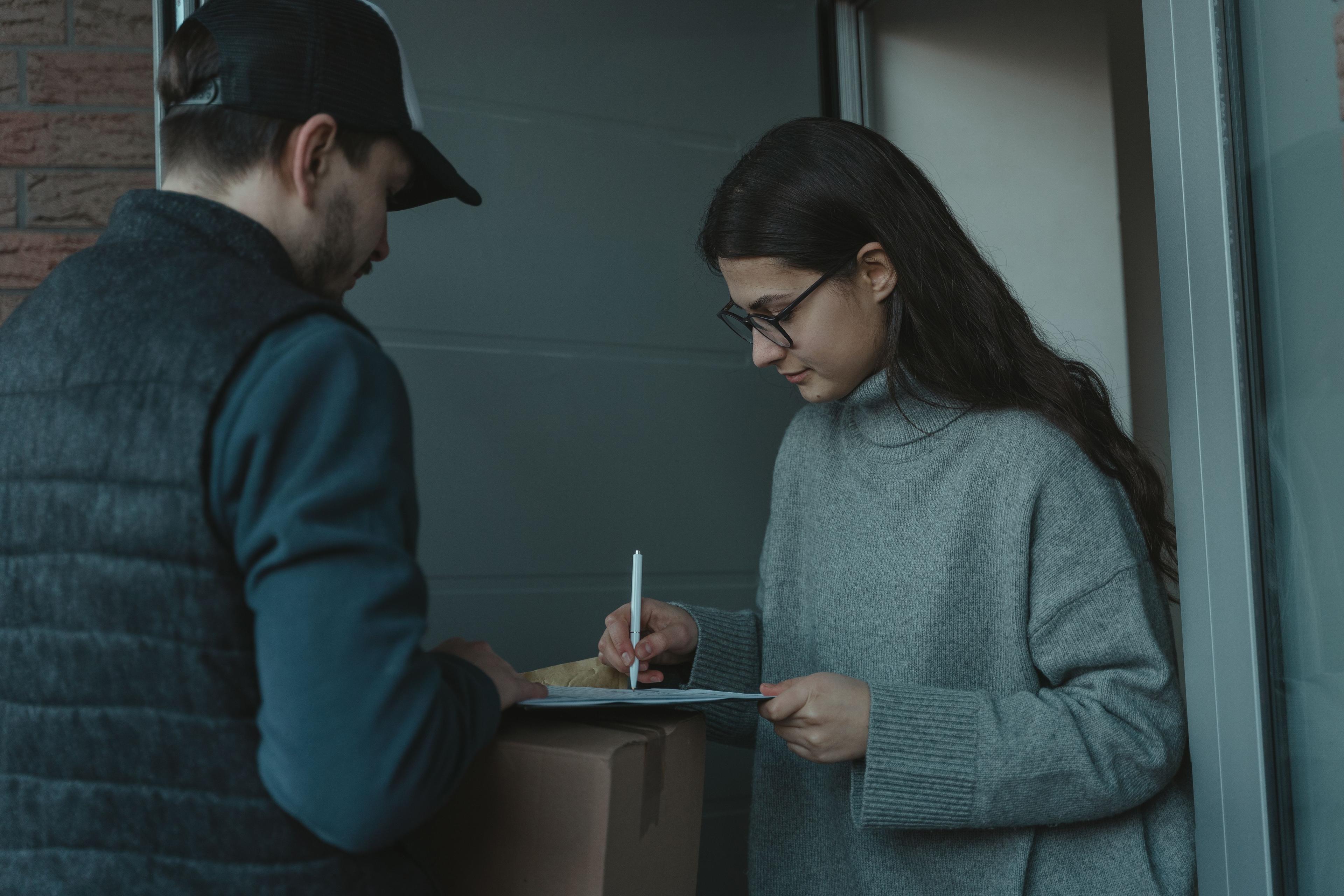 Cash on delivery courier service - courier collecting payment from a customer at the doorstep